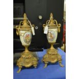 A pair of ormolu style and porcelain urn shaped ornaments (af).