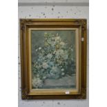 After Renoir, oleographic study of flowers in a vase in a decorative gilt frame.