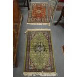Two small Persian design rugs, one green ground the other red each 100cm x 63cm.