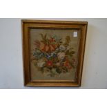 A woolwork picture depicting flowers in a decorative gilt frame.