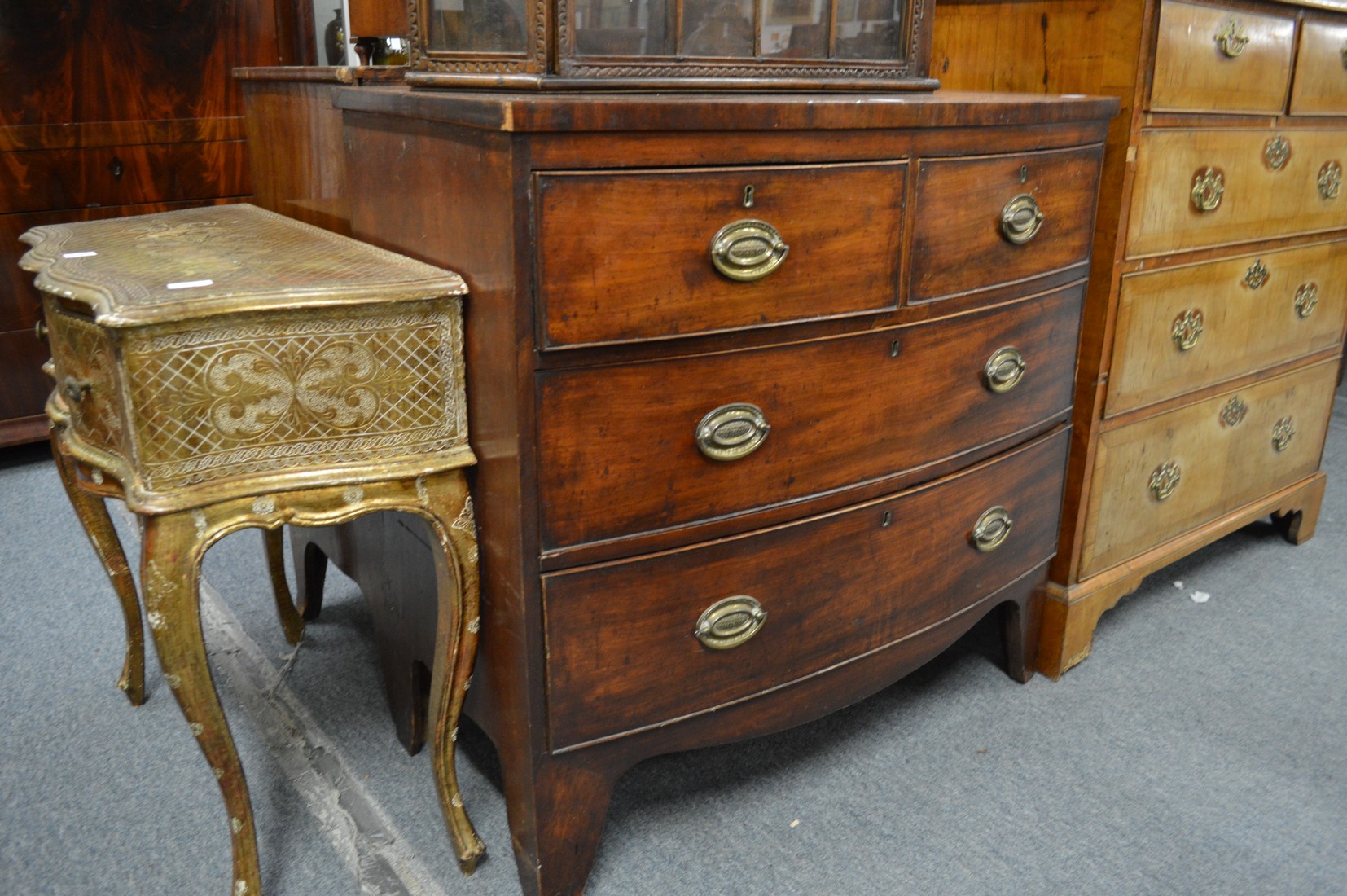 A 19th century mahogany bow front chest of two short and two long drawers on bracket feet.