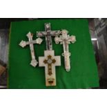 Four mother-of-pearl and other crucifixes.