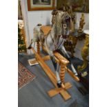 A good large dapple grey rocking horse on pine base.