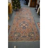 A pair of Persian rugs, rust ground with floral decoration each 195cm x 135cm.