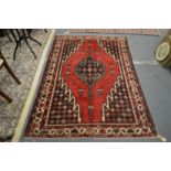 A Persian Hamadan rug red ground with stylised decoration 200cm x 140cm.