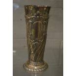 A large silver tapering vase with embossed and engraved decoration.