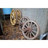 Two pairs of wagon wheels.