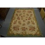 A French woolwork carpet with floral decoration. 200cm x 140cm.