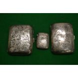 Two engraved silver cigarette cases and a vesta case.