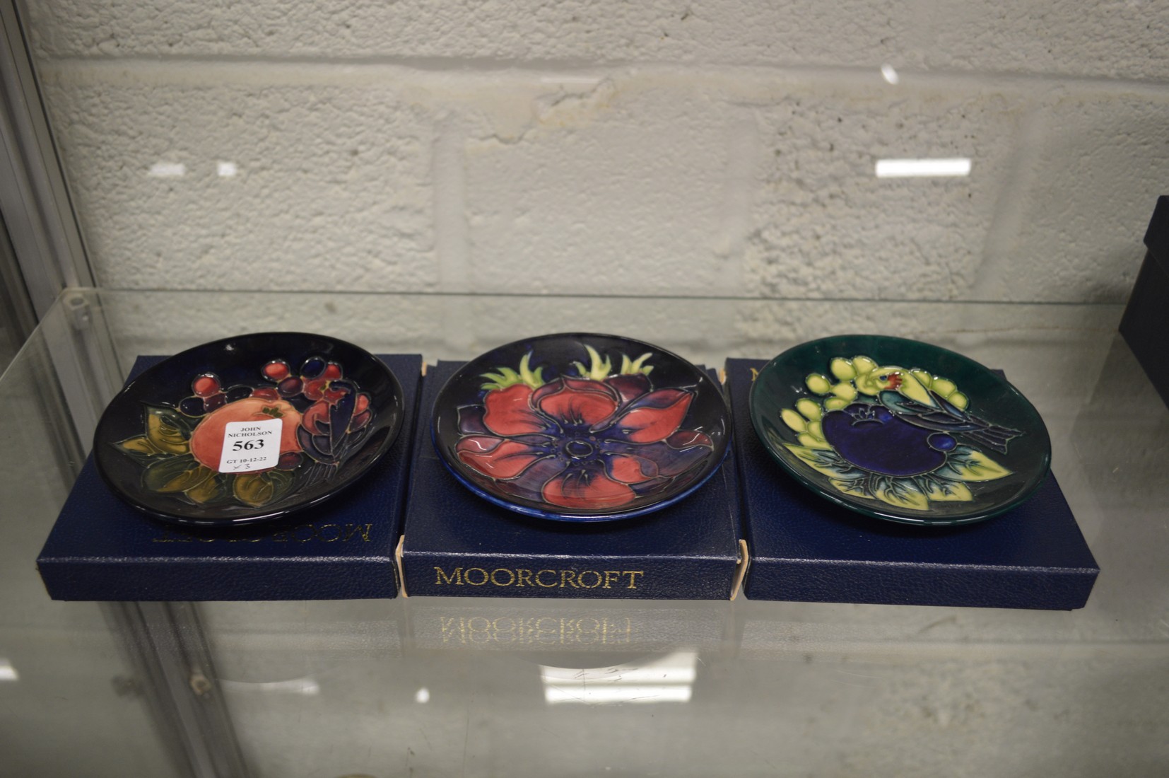 Three Moorcroft small circular dishes with original boxes.