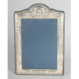 A LARGE SILVER UPRIGHT PHOTOGRAPH FRAME with ribbons motif. 9ins x 6.5ins.