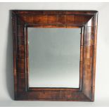 A GOOD 18TH CENTURY WALNUT CUSHION FRAMED MIRROR. 1ft 11in high, 1ft 8ins wide.