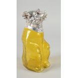 A LARGE YELLOW GLASS AND SILVER PLATED BEAR CLARET JUG with glass eyes. 9ins high.