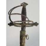 A BRASS HILTED RAPIER with fullered double edge blade and engraved, signed blade in a brown