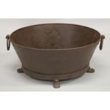 A LARGE OVAL METAL PLANTER on claw and ball feet. 26ins wide.