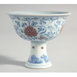 A CHINESE MING STYLE BLUE, WHITE AND UNDERGLAZE RED PEDESTAL CUP, the interior with four-character