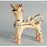 A TURKISH OTTOMAN CANNAKALE GLAZED POTTERY FIGURE OF A LION, 20cm long.