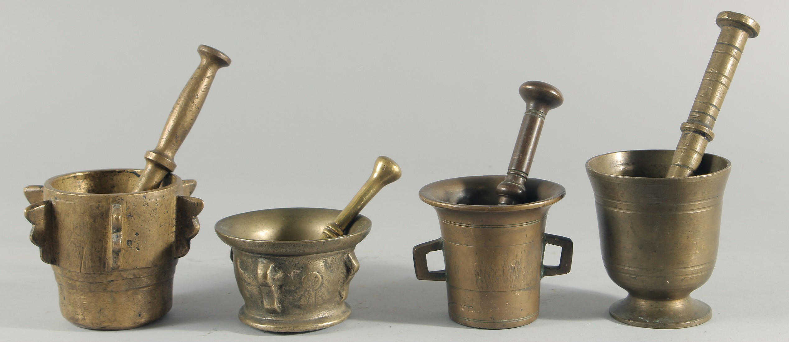 A COLLECTION OF FOUR BRONZE PESTLE AND MORTARS, (eight pieces).