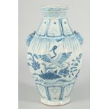 A CHINESE OCTAGONAL BLUE AND WHITE TWIN HANDLE VASE, with moulded lion heads as handles, the body