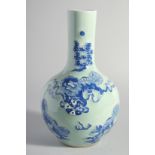 A LARGE CHINESE CELADON GROUND BLUE AND WHITE PORCELAIN VASE, decorated with foo dogs, 34.5cm high.