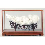 A SUPERB CHINESE PORCELAIN FLORAL SCULPTURE elevated on a hardwood stand, contained within a glass