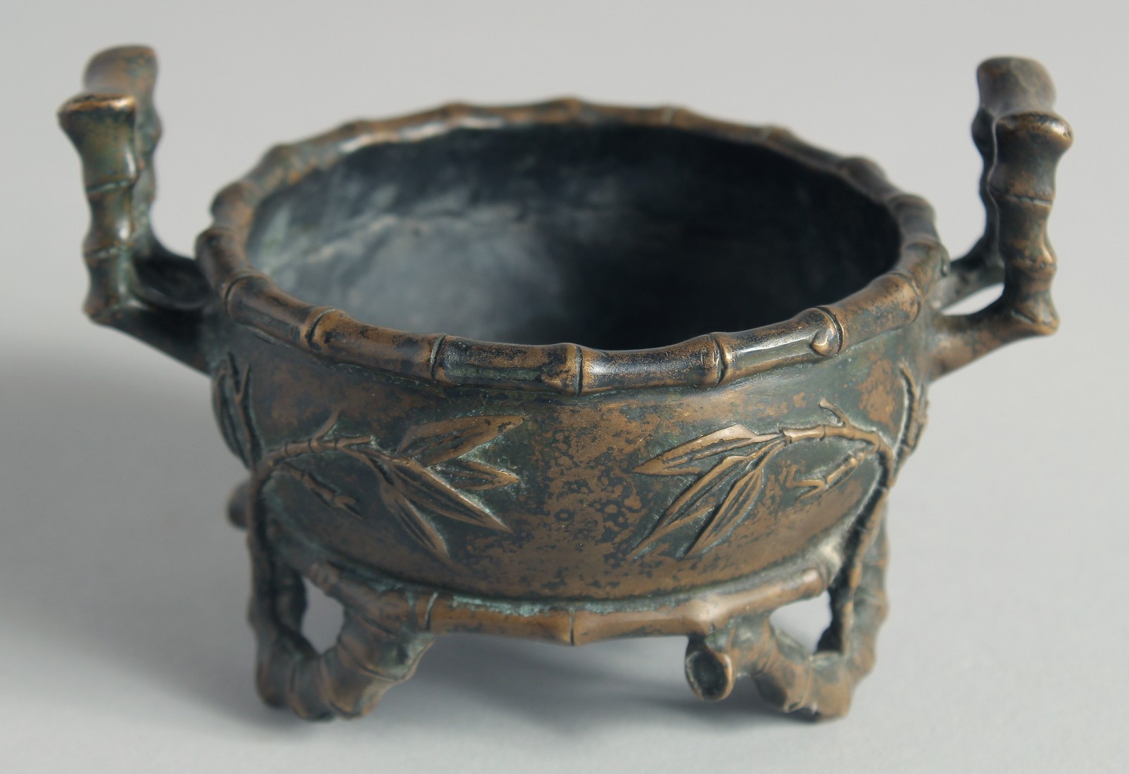 A SMALL CHINESE BRONZE CENSER, with bamboo formed handles and feet, the base with Xuande mark,