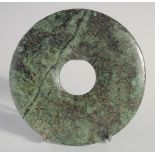 A SMALL HARDSTONE BI DISK, 12.5cm diameter.