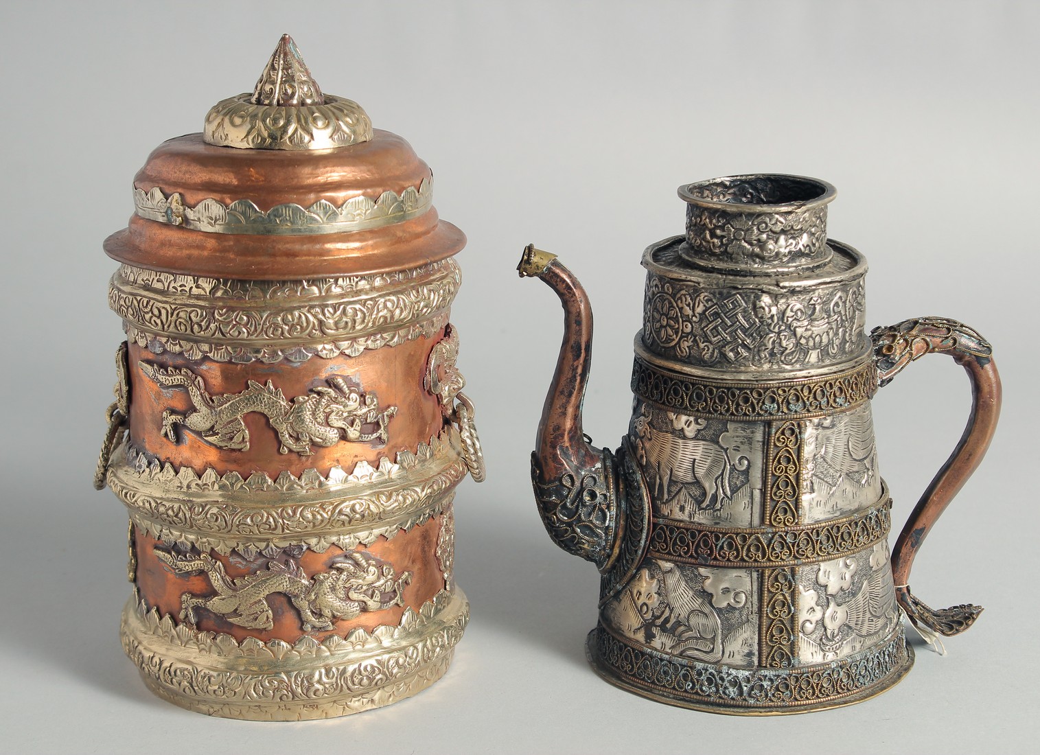 AN UNUSUAL CHINESE EMBOSSED METAL EWER, the embossed and chased decoration depicting panels of