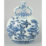 A CHINESE BLUE AND WHITE PORCELAIN TWIN HANDLE MOON FLASK, decorated with native flora, bearing