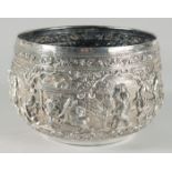 A VERY FINE AND LARGE 19TH CENTURY BURMESE SILVER BOWL, relief-decorated with figures and animals,