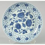 A CHINESE BLUE AND WHITE PORCELAIN CHARGER, decorated with flower heads and vine, 33.5cm diameter.