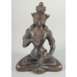 A BRONZE FIGURE OF A SEATED DEITY holding a vajra, 16cm high.