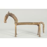 AN ISLAMIC BRASS FIGURE OF A STYLISED HORSE, 24.5cm long.