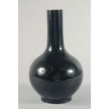 A CHINESE FAMILLE NOIR PORCELAIN BOTTLE VASE, the base with six-character mark, 28.5cm high.