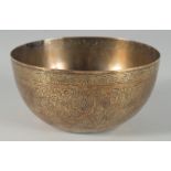 A 19TH CENTURY PERSIAN QAJAR ENGRAVED BRASS BOWL, 12.5cm diameter.