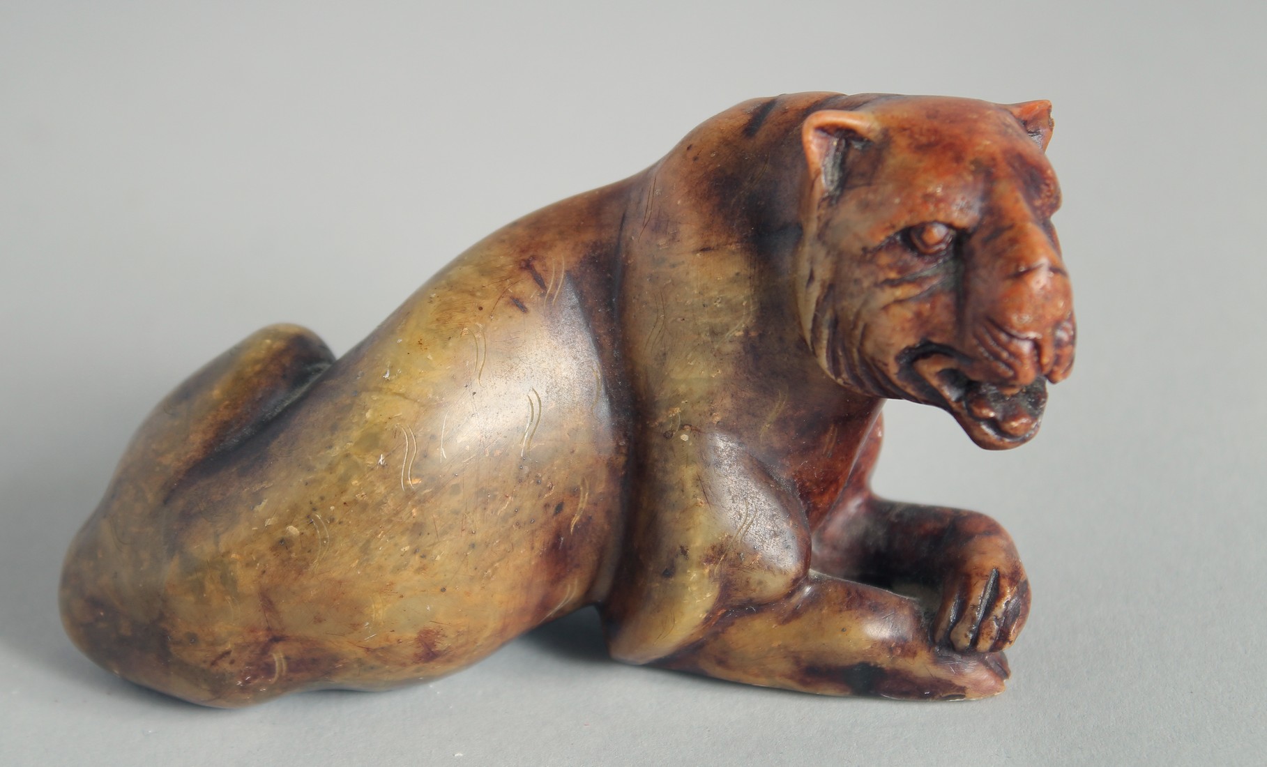 A CARVED HARDSTONE FIGURE OF A TIGER, 11cm long.