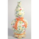 A CHINESE FAMILLE ROSE PORCELAIN DOUBLE GOURD VASE, decorated with gourds and moulded ribbon to