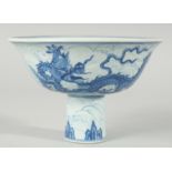 A CHINESE BLUE AND WHITE PORCELAIN STEM CUP, decorated with dragons on a wave-pattern ground,