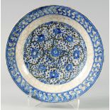 AN EARLY 17TH CENTURY SAFAVID BLUE AND WHITE "KUBACHI" POTTERY DISH, probably Tabriz, Iran, with