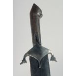 AN EARLY PERSIAN SWORD WITH WATERED STEEL BLADE AND RHINO HORN HANDLE, with leather covered