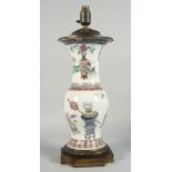 A LARGE CHINESE FAMILLE ROSE PORCELAIN VASE LAMP, the body painted with potted flowers, vases and