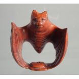 A JAPANESE BOXWOOD NETSUKE OF A BAT.