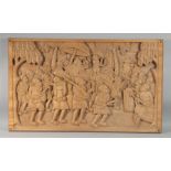 A LARGE BALINESE CARVED WOODEN PLAQUE, depicting a scene with a musical gathering, 62cm x 103cm.