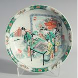 A CHINESE FAMILLE VERTE PORCELAIN DISH, painted with female figures playing a board game with a