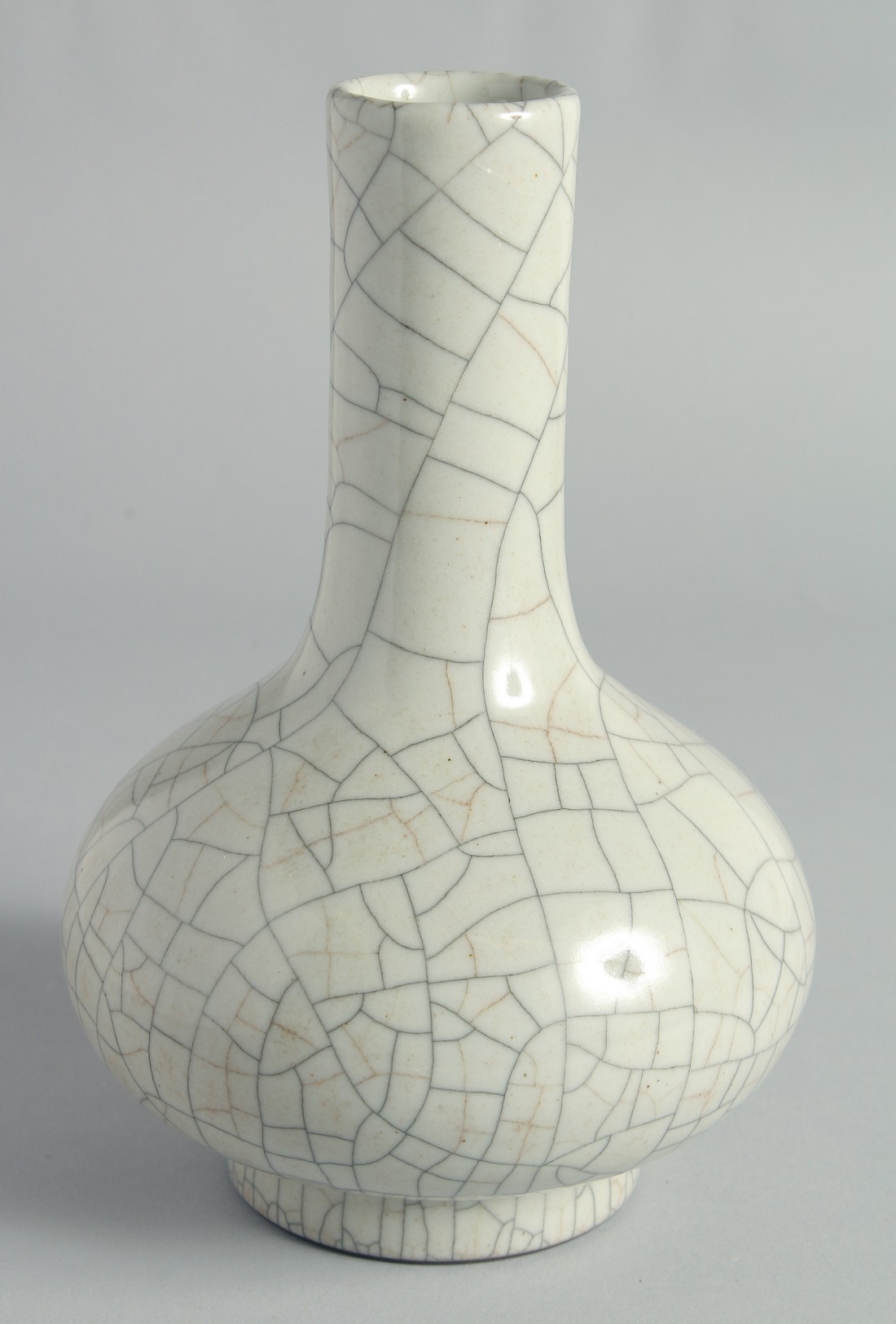 A CHINESE CRACKLE GLAZE BOTTLE VASE, the base with six-character mark, 23cm high.