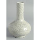 A CHINESE CRACKLE GLAZE BOTTLE VASE, the base with six-character mark, 23cm high.