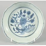 A CHINESE BLUE AND WHITE PORCELAIN PETAL FORM BOWL, the interior with central floral spray, exterior