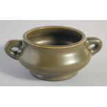 A SMALL CHINESE TEA DUST GLAZE TWIN HANDLE CENSER, with character mark to base, 13cm (handle to
