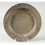 A 13TH CENTURY SELJUK BRASS TRAY, with engraved decoration, 24cm diameter.