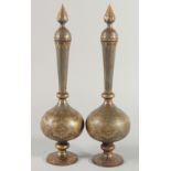 A GOOD PAIR OF ISLAMIC IRON LIDDED BOTTLES, with gilt decoration and panels of calligraphy, 41cm